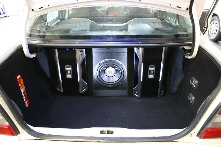 Alarm and security system wiring being installed under a car dashboard